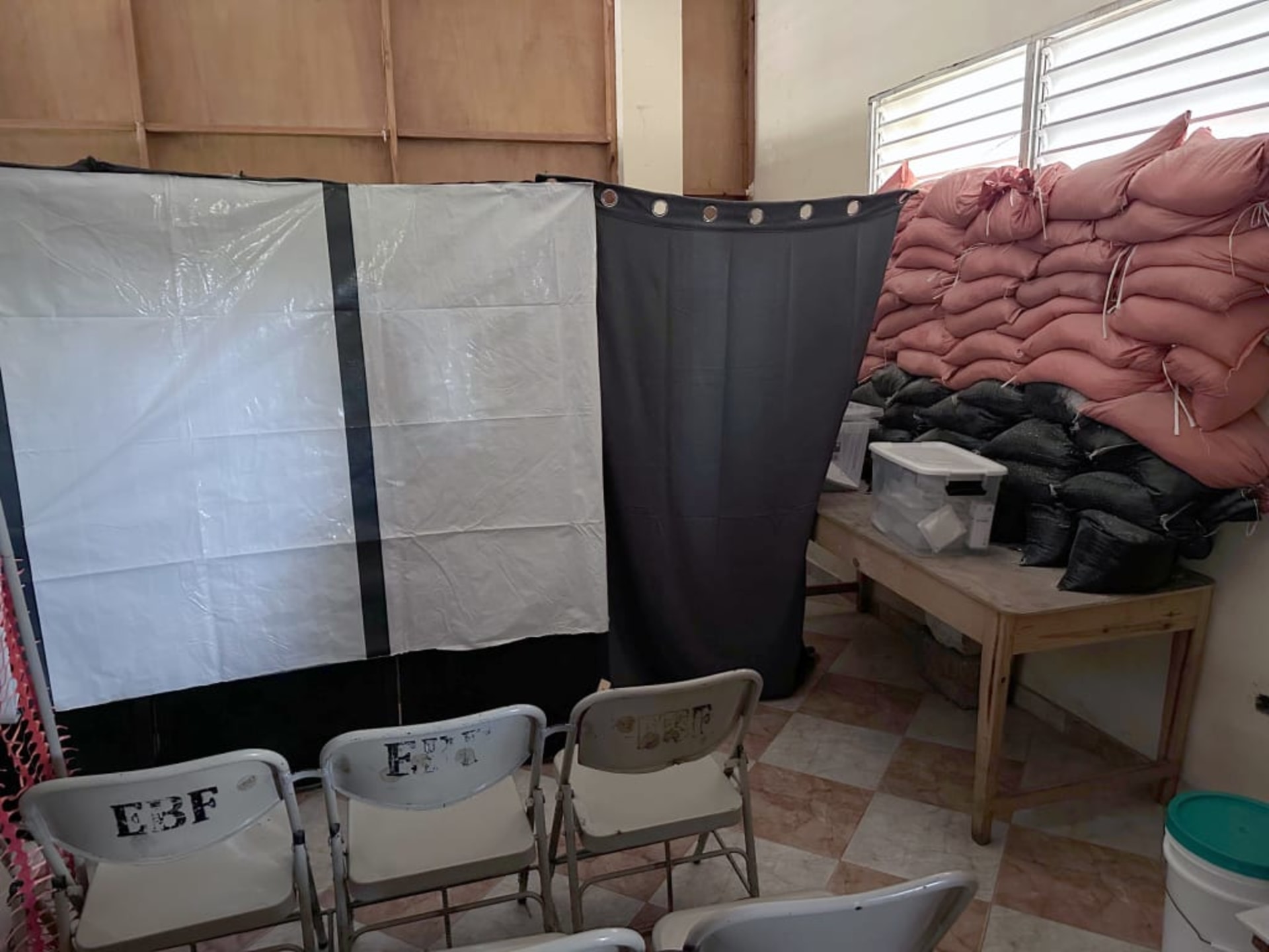 A photo of sandbags stacked in the window of a church