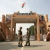 Indian border security force soldiers prtrol in front of Wagah border gate.