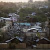 A woman walks past a burnt Islamic school in Meikhtila.