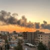 Smoke billows over apartment buildings in Khartoum.