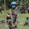 A peacekeeper holds his weapon during a patrol around the new base set up in Rugari as the population watches the military in eastern Democratic Republic of Congo, January 28, 2022. Glody Marhabazi/Getty