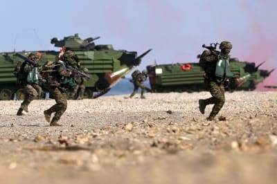 Soldiers exit an amphibious assault vehicle