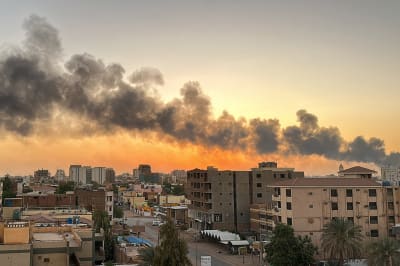 Smoke billows over apartment buildings in Khartoum.