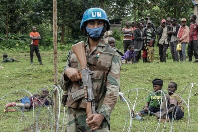 A peacekeeper holds his weapon during a patrol around the new base set up in Rugari as the population watches the military in eastern Democratic Republic of Congo, January 28, 2022. Glody Marhabazi/Getty