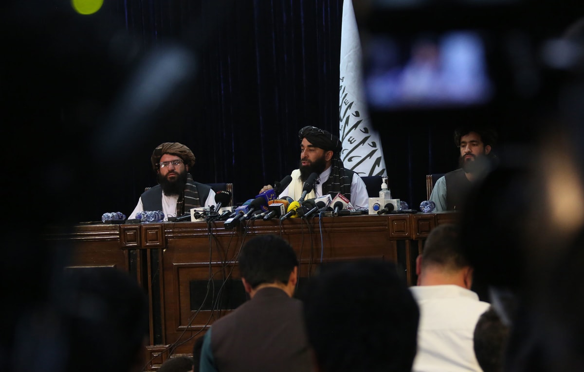 The Taliban spokesman Zabihullah Mujahid (C, Rear) attends a press conference in Kabul, capital of Afghanistan, on Aug. 17, 2021.