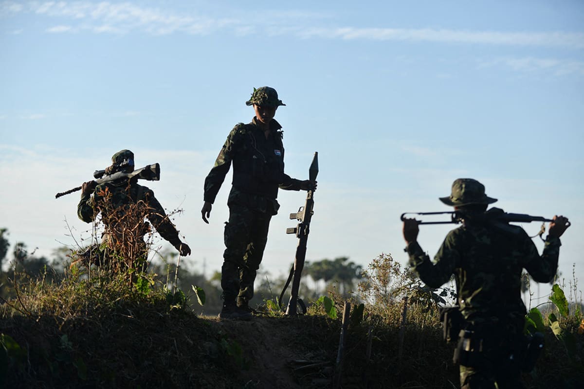 Guerrilla fighters after being protesters are seen on the front line
