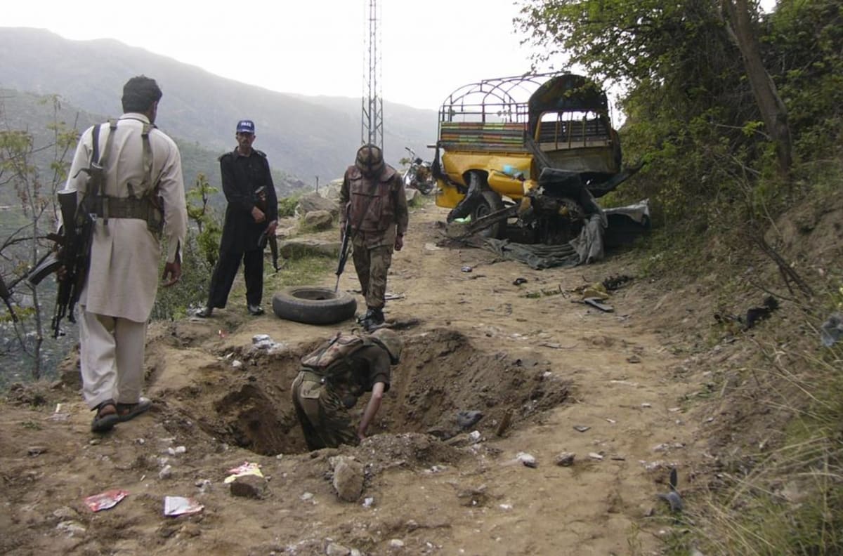 Army members investigate the site of a deadly Improvised Explosive Device (IED) attack on April 14, 2013.