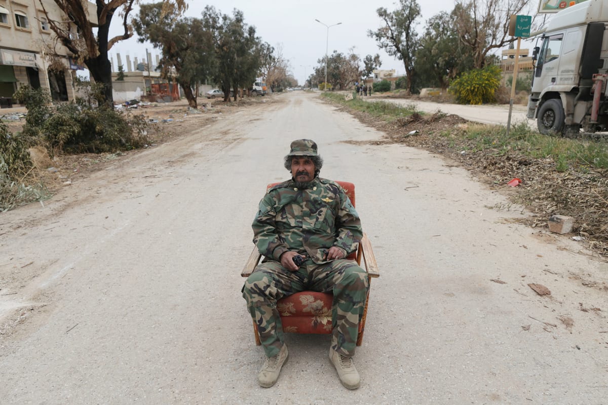 A member of East Libyan forces sits in an armchair on Tripoli road which was opened after forces captured the final holdout of Islamist-led rivals in southwest Benghazi, Libya on March 21, 2017. 