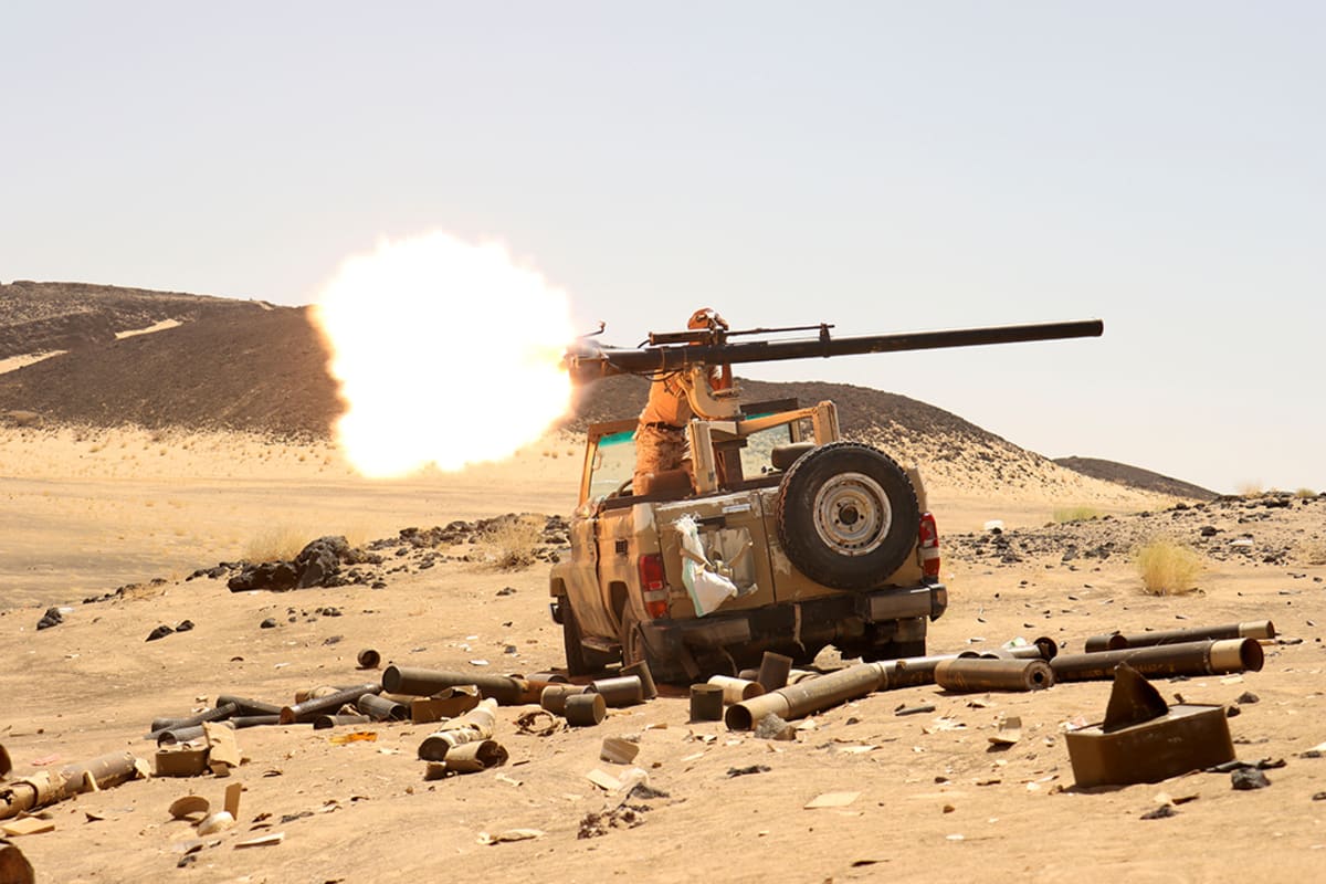 A Yemeni government fighter fires a weapon at a frontline position during fighting against Houthi fighters in Marib, Yemen, on March 9, 2021.