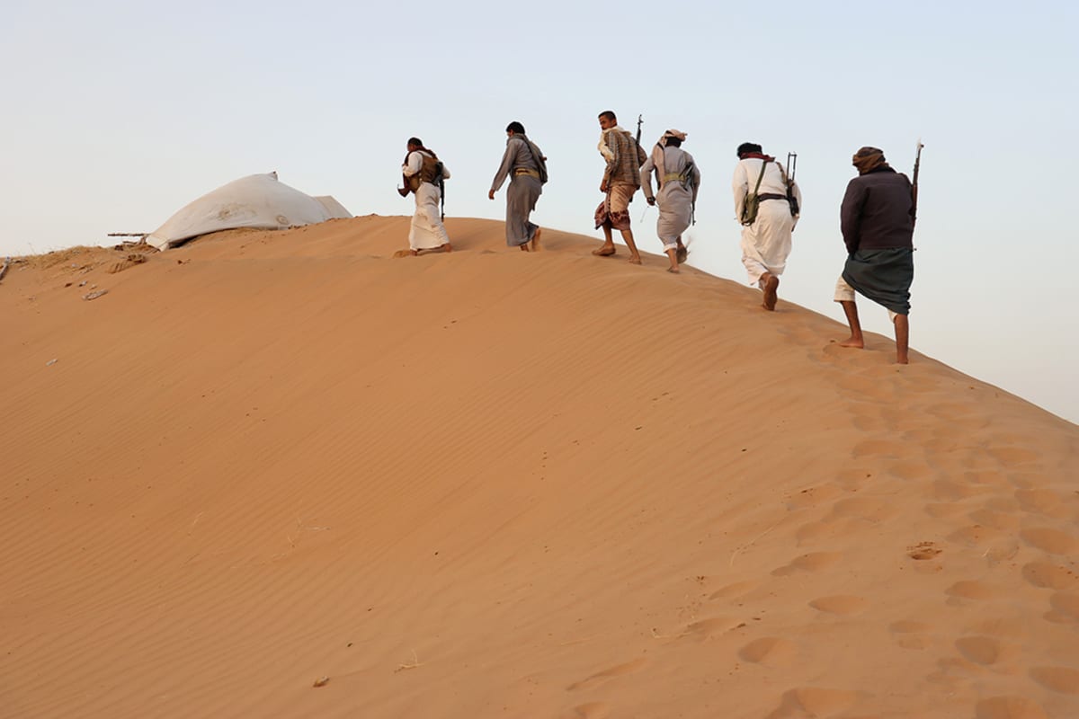 Armed men loyal to Yemen’s internationally-recognized government guard a site near the Safer oil fields in Marib, Yemen, on September 12, 2021. 