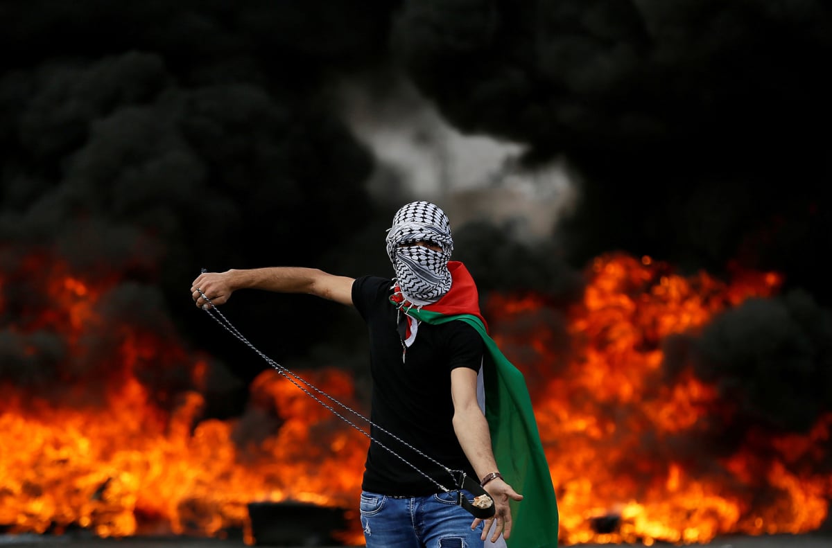 A Palestinian demonstrator holds a sling during a protest marking the seventieth anniversary of the Nakba near the Jewish settlement of Beit El, near Ramallah in the West Bank. 