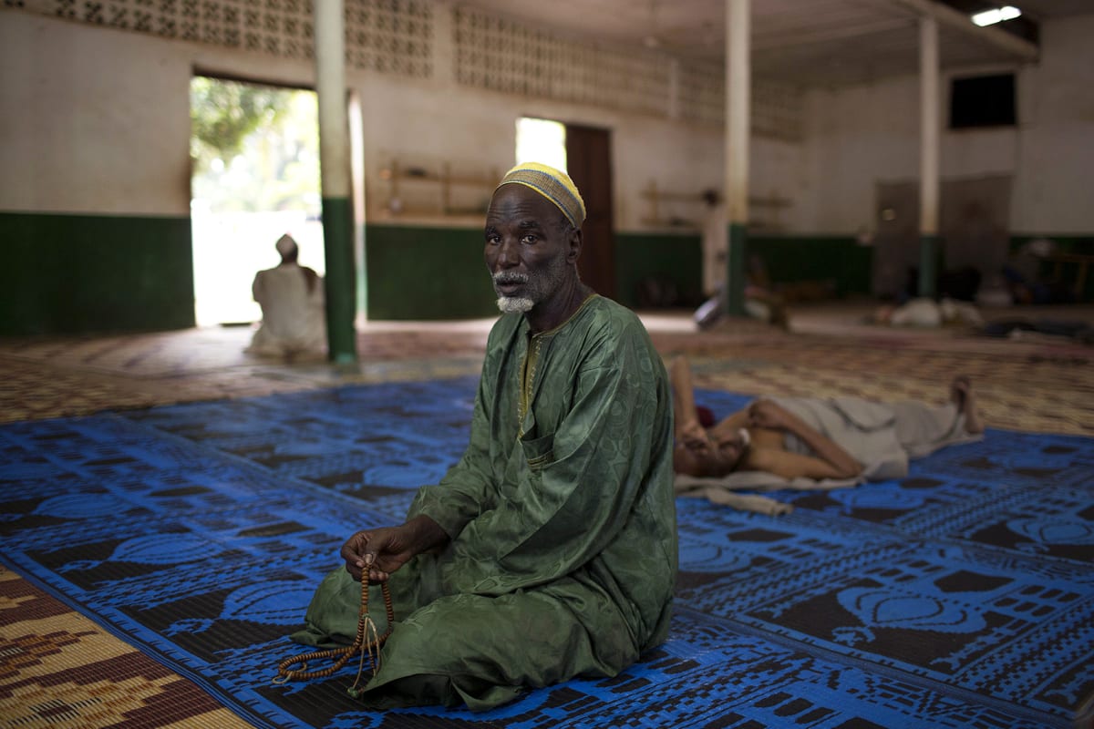 A man prays in a mosque near Kilometer 12 (PK12) where internally displaced Muslims are stranded due to ongoing sectarian violence in the capital of Bangui, Central African Republic on March 19, 2014. 