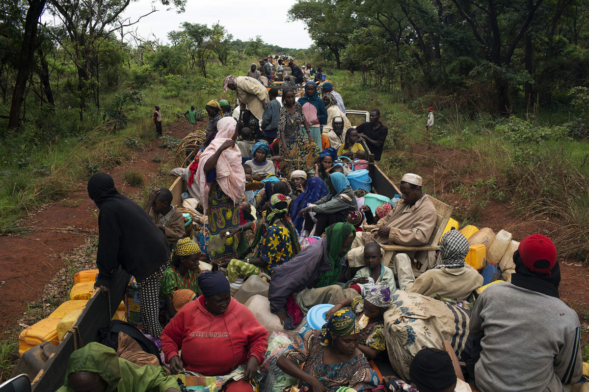 Internally displaced persons (IDPs) take a break on an armed African Union peacekeeping convoy escorting about one thousand Muslims from the capital of Bangui to the norther towns of Kabo and Sido in the Central African Republic on April 28, 2014. 