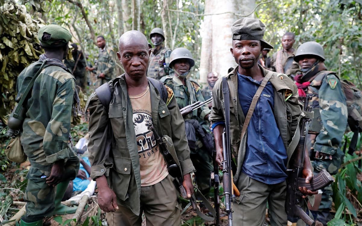 Congolese soldiers from the Armed Forces of the Democratic Republic of Congo (FARDC) rest in the forest after the army took control of an Allied Democratic Forces (ADF) rebel camp near the town of Kimbau, North Kivu Province, Democratic Republic of Congo on February 18, 2018. 