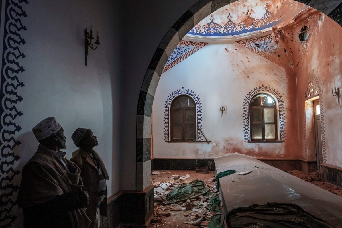 Ethiopian Muslims stand inside a damage mausoleum at the al-Nejashi Mosque, one of the oldest in Africa and allegedly damaged by Eritrean forces shelling, in Negash, Ethiopia, on March 1, 2021. 