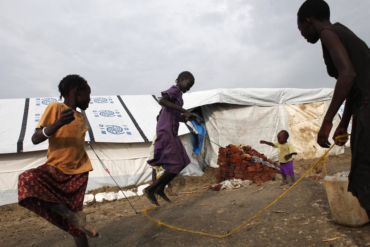 Girls play in an internally displaced persons (IDP) camp outside the UN base in Malakal, South Sudan on July 24, 2014. 