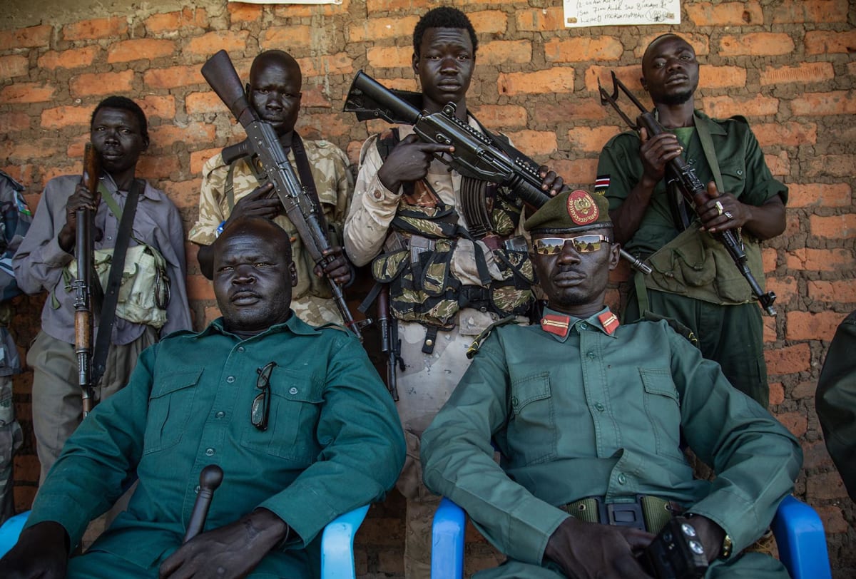 Brigadier General Lemi Lomukaya (front R) of the Sudan People’s Liberation Movement-in-Opposition (SPLM-IO), a South Sudanese antigovernment force, poses with rebels at a base in Birigo, on the South Sudanese side of the border with Uganda, on September 22, 2018. 