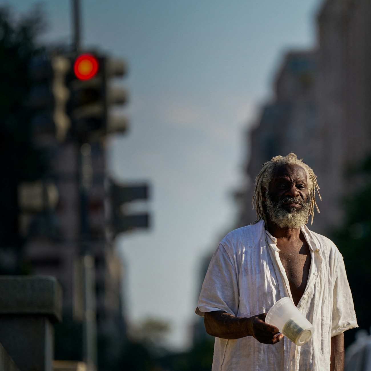 Nathaniel, who is homeless, panhandles near the National Mall after U.S. President Donald Trump federalized the Metropolitan Police Department and deployed National Guard to assist in crime prevention, in Washington, DC, on August 15, 2025.