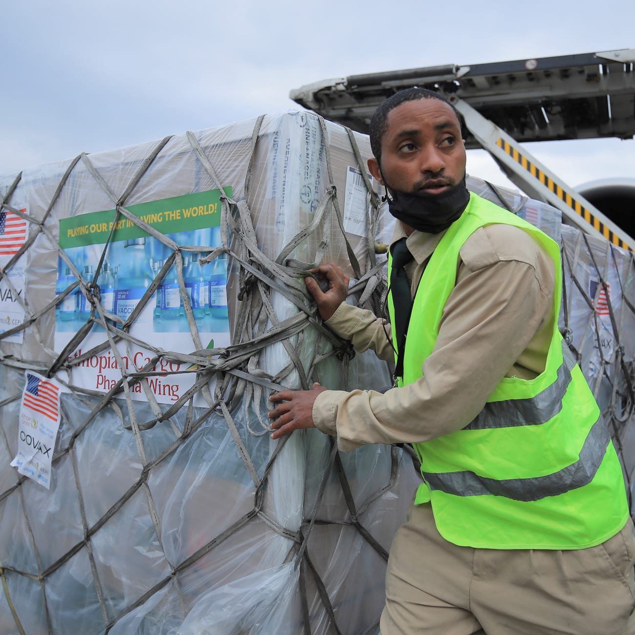 An Ethiopian Cargo terminal worker offloads a shipment of Johnson and Johnson's COVID-19 vaccines that arrived under the COVAX scheme, at the Bole International Airport, in Addis Ababa, Ethiopia, on July 19, 2021.