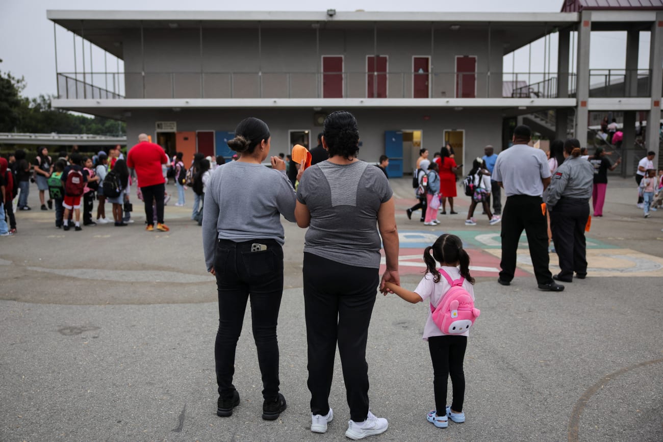 Parents and students arrive for the first day of school, as teachers and volunteers patrol for the presence of Immigration and Customs Enforcement (ICE), at the Ninety-Third Street Elementary School, in Los Angeles, California, on August 14, 2025.
