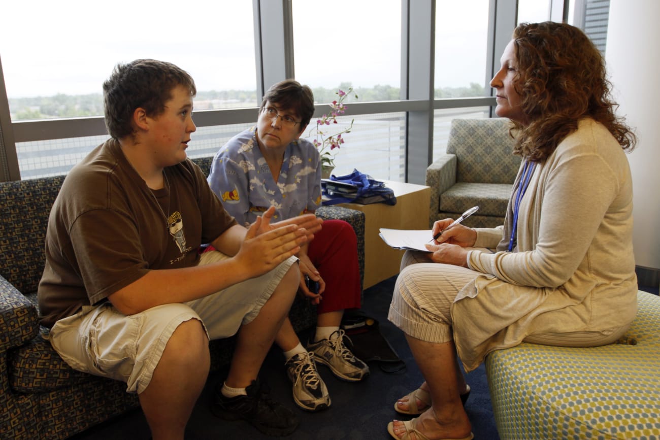 Micah Peterson, 15, and his mother talk with Marilyn Day, director of a child and teen weight management program, during a counseling session at The Children's Hospital, in Aurora, Colorado, on July 8, 2010.
