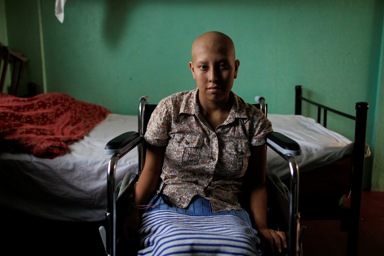 Norma del Carme Blandin, a cancer patient, sits in a wheelchair inside her bedroom, at the Casa-Albergue, in Managua, Nicaragua, on October 20, 2017.