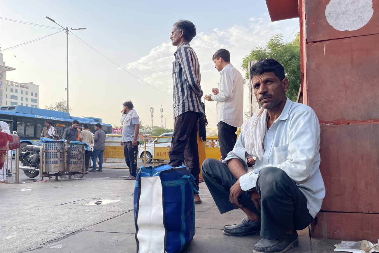 Ramesh Kumar, 45, sits outside a public hospital after another day spent seeking affordable tuberculosis treatment, at Ram Manohar Lohia Hospital, in New Delhi, on November 28, 2025.