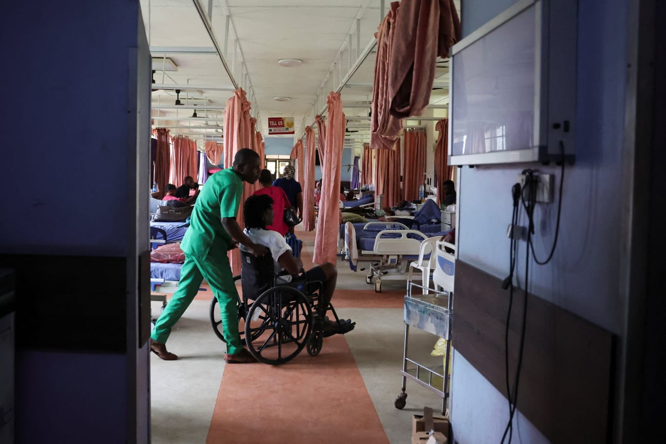 An injured patient is wheeled out of the out-patient ward of the National Orthopaedic Hospital, in Lagos, Nigeria, on July 30, 2025.
