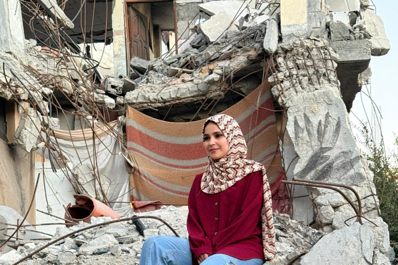Project HOPE Gaza Human Resources Coordinator Nouralhuda Abu Gefra sits in the rubble of her partially damaged house in Gaza, on October 14, 2025.
