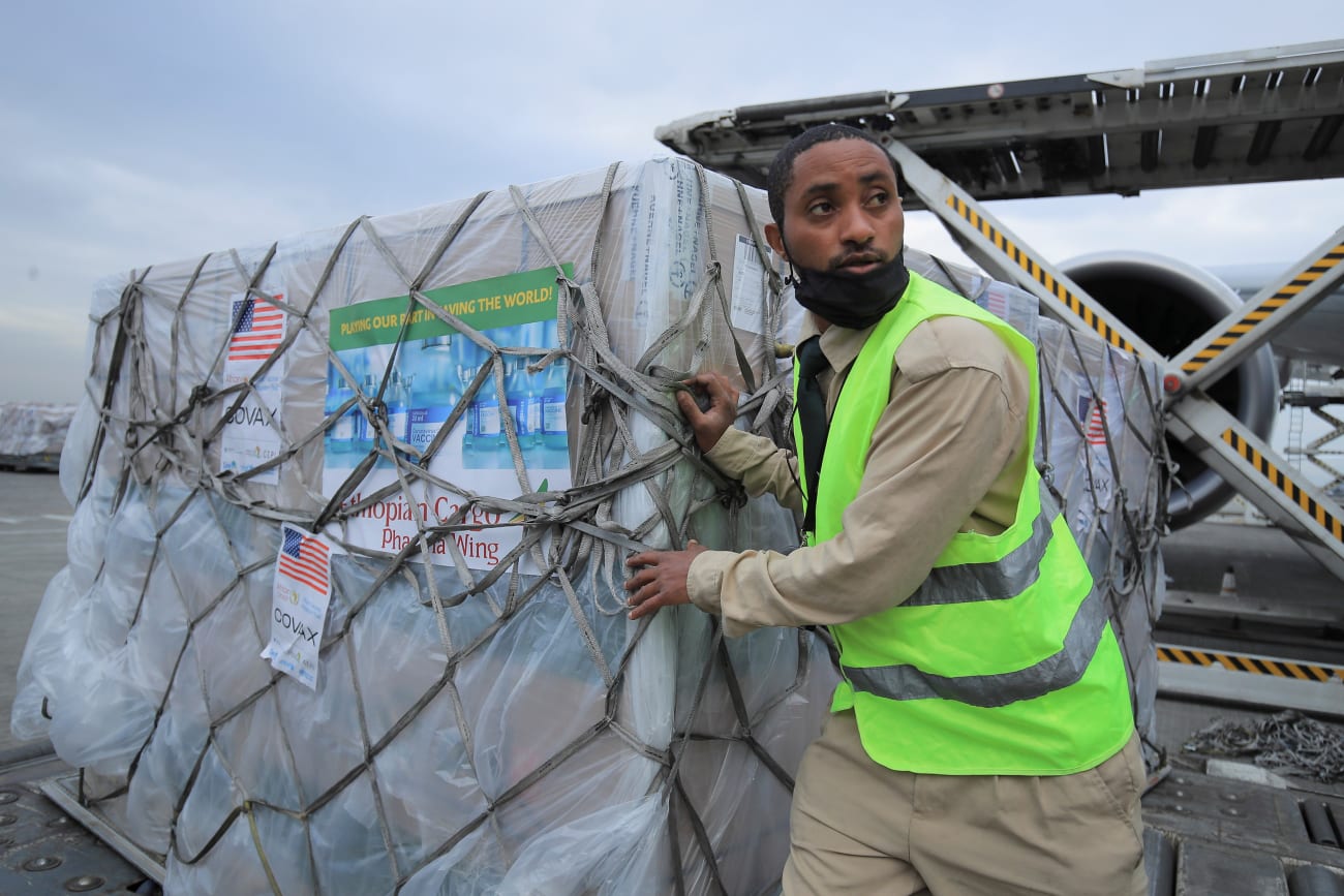An Ethiopian Cargo terminal worker offloads a shipment of Johnson and Johnson's COVID-19 vaccines that arrived under the COVAX scheme, at the Bole International Airport, in Addis Ababa, Ethiopia, on July 19, 2021.