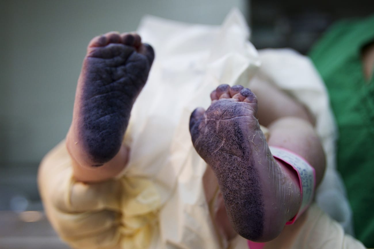 A newborn baby's inked feet are seen after his footprints were taken for the birth certificate, at the Santa Ana public maternity hospital, in Caracas, Venezuela, on October 19, 2011.