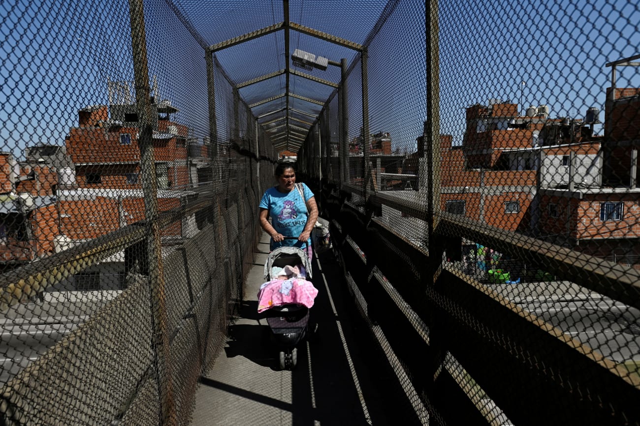 A woman pushes a baby stroller, in Villa Soldati, Argentina, on September 16, 2024.