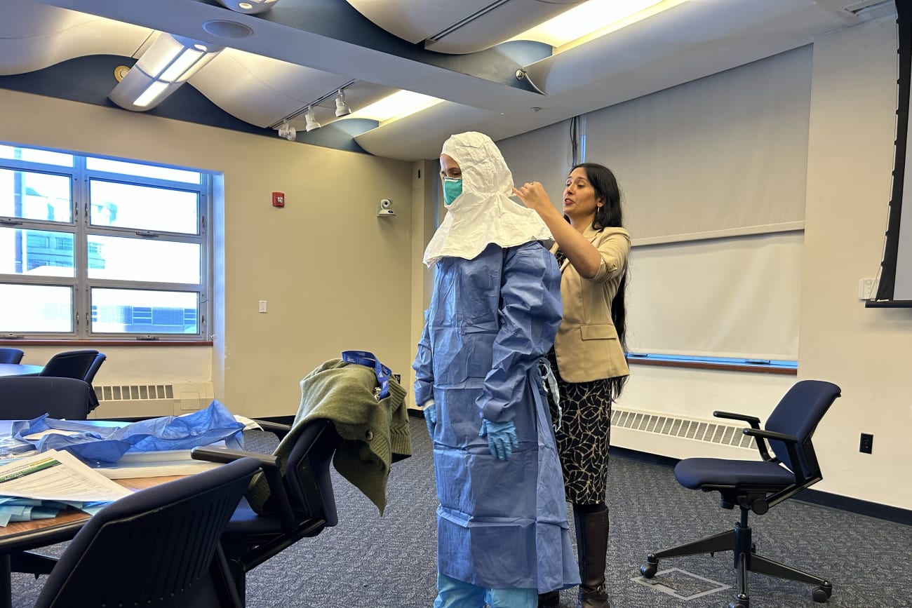 A volunteer is guided through the full donning sequence for special pathogen personal protective equipment during a training seminar led by Syra Madad, chief biopreparedness officer for NYC Health + Hospitals, on February 2, 2026.