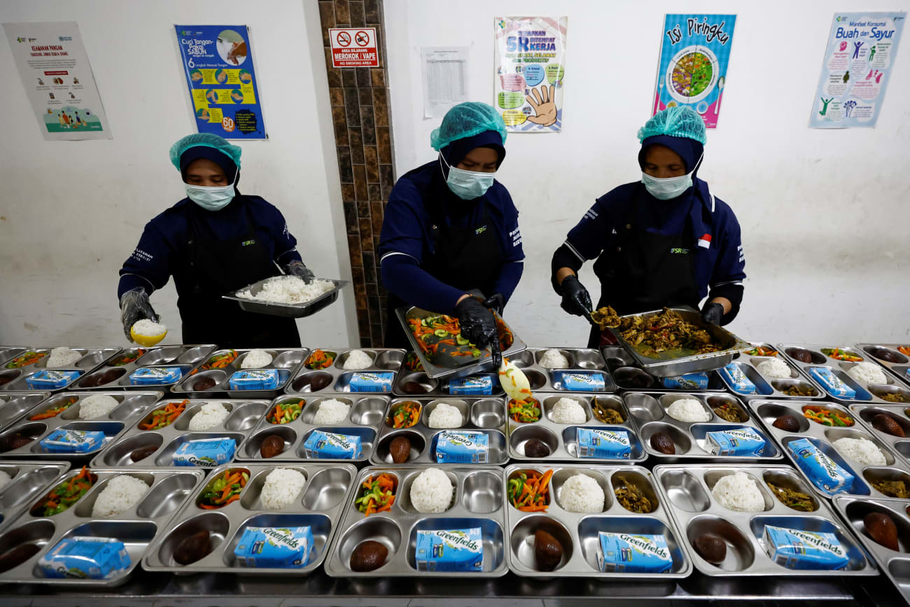Workers prepare meals to be distributed free for students, during the free nutritious meals program trial, at a pilot kitchen in Sukabumi, West Java province, Indonesia, September 25, 2024.