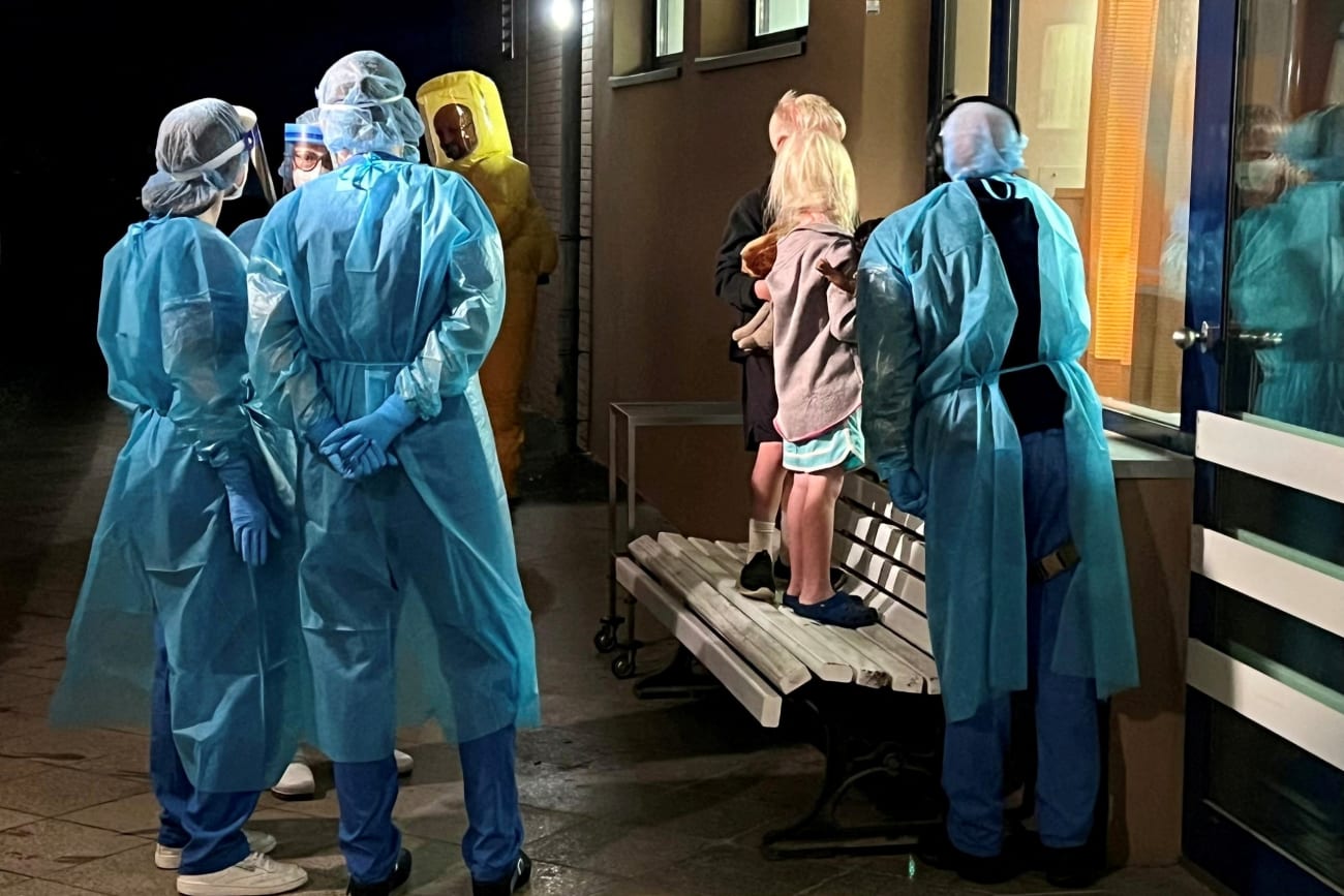 Two children of an American Ebola patient look through a window at their father in the isolation ward, at the Charite hospital in Berlin, Germany, on May 21, 2026.