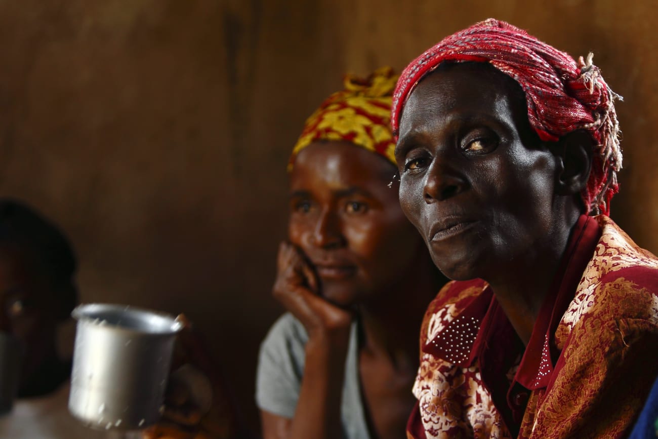 HIV-positive members of a self-help group meet with a caregiver in the village of Michelo, Zambia, on February 23, 2015.