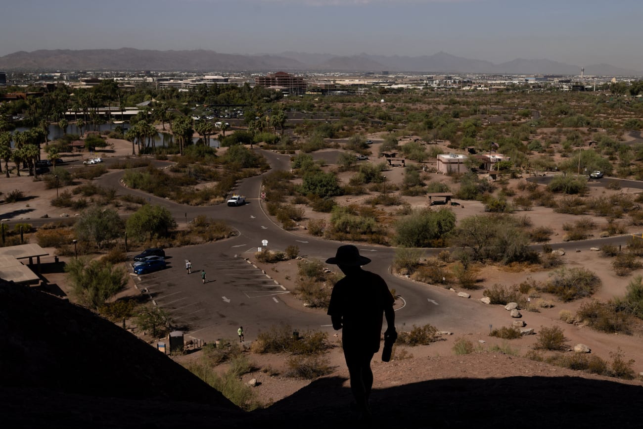 A man walks on a trail during a 27 days long heat wave with temperatures over 110 degrees Fahrenheit (43 degrees Celsius), in Phoenix, Arizona, on July 26, 2023.