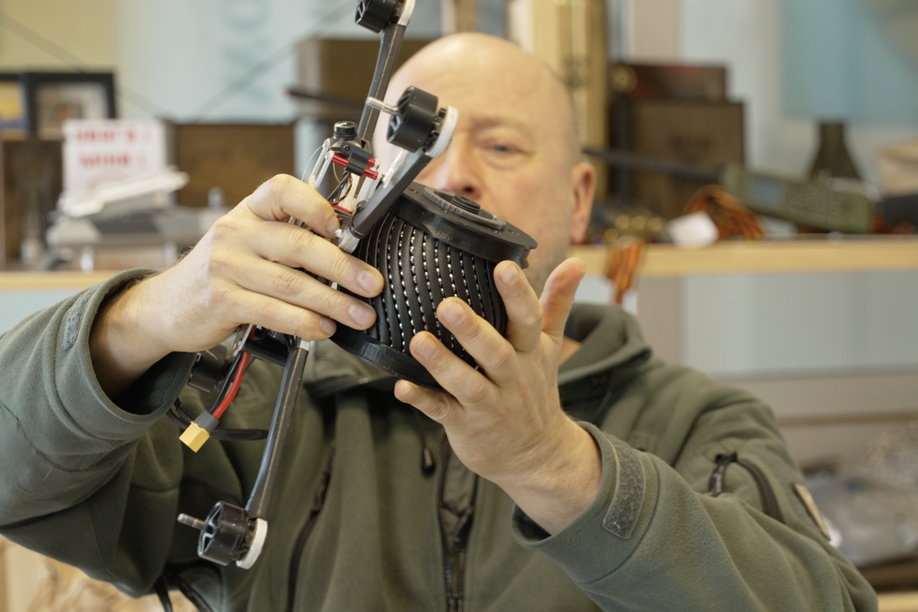 NGO Blue/Yellow co-founder Jonas Ohman puts an inert, drone-carried explosive on a drone at the NGO headquarters in Vilnius, Lithuania, in March 2026.