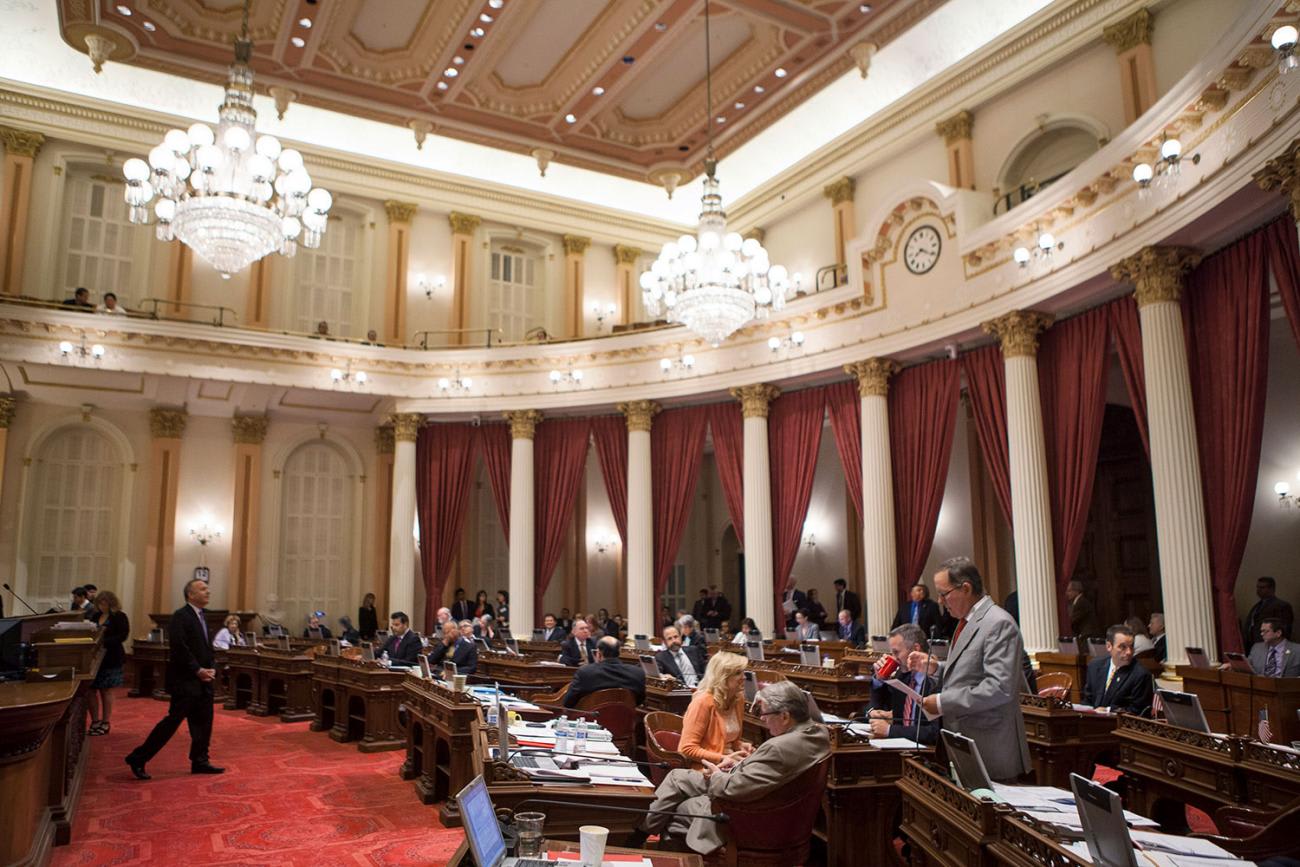 The California Legislature, part of which is shown here in this September 12, 2013 photo, passed the new Truvada law in October, 2019. The picture shows a stately legislative chambder with high ceilings, red carpets, and people sitting behind semicircular benches. REUTERS/Max Whittaker
