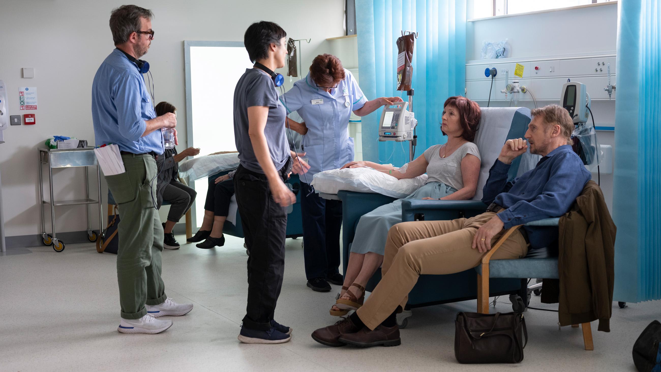 Picture is taken during production of the film in a scene where the couple is in a hospital ward. Various production folks can be seen in the shot.