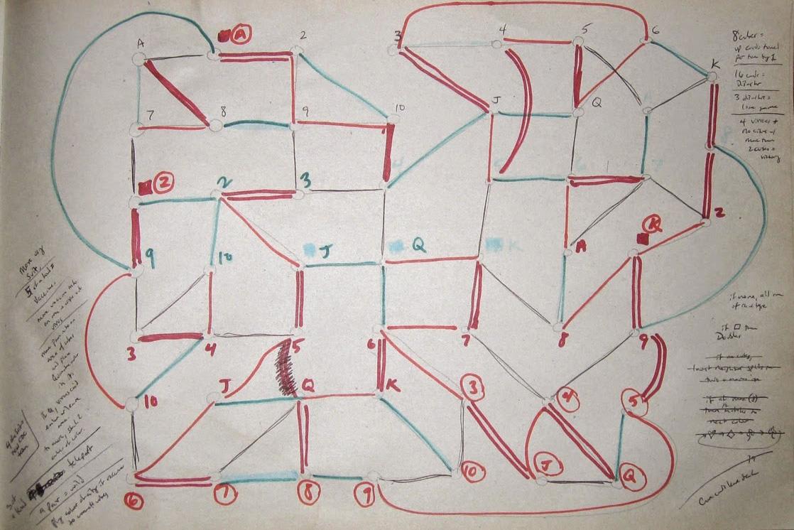Photo shows a yellowed piece of paper heavily worked with pencil, pen, and blue and red marker. The paper has a rough sketch with numbers and letter connected by marker.