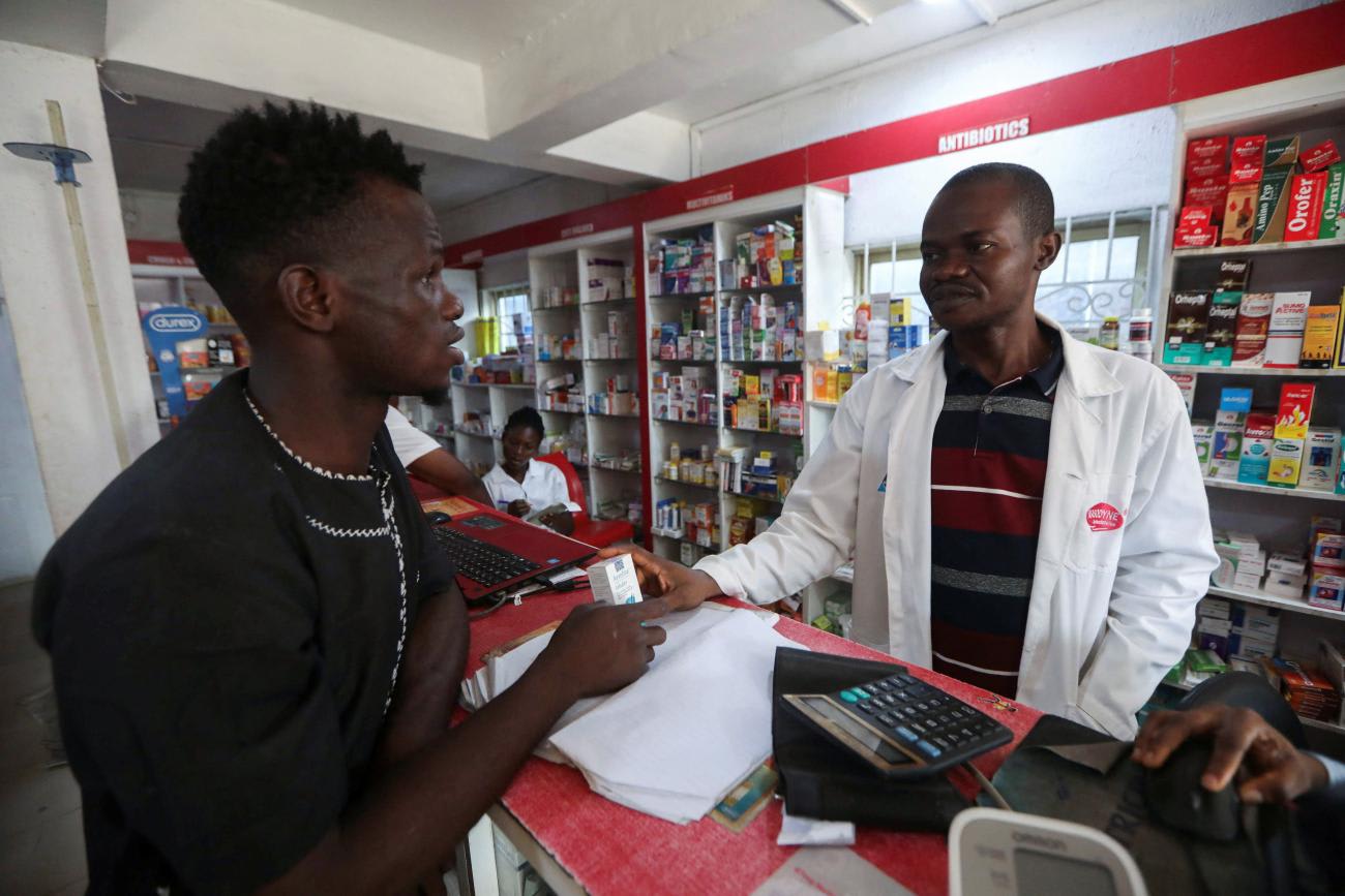 A man speaks to a pharmacist about his medication at a pharmacy, in Lagos, Nigeria, on December 11, 2023.