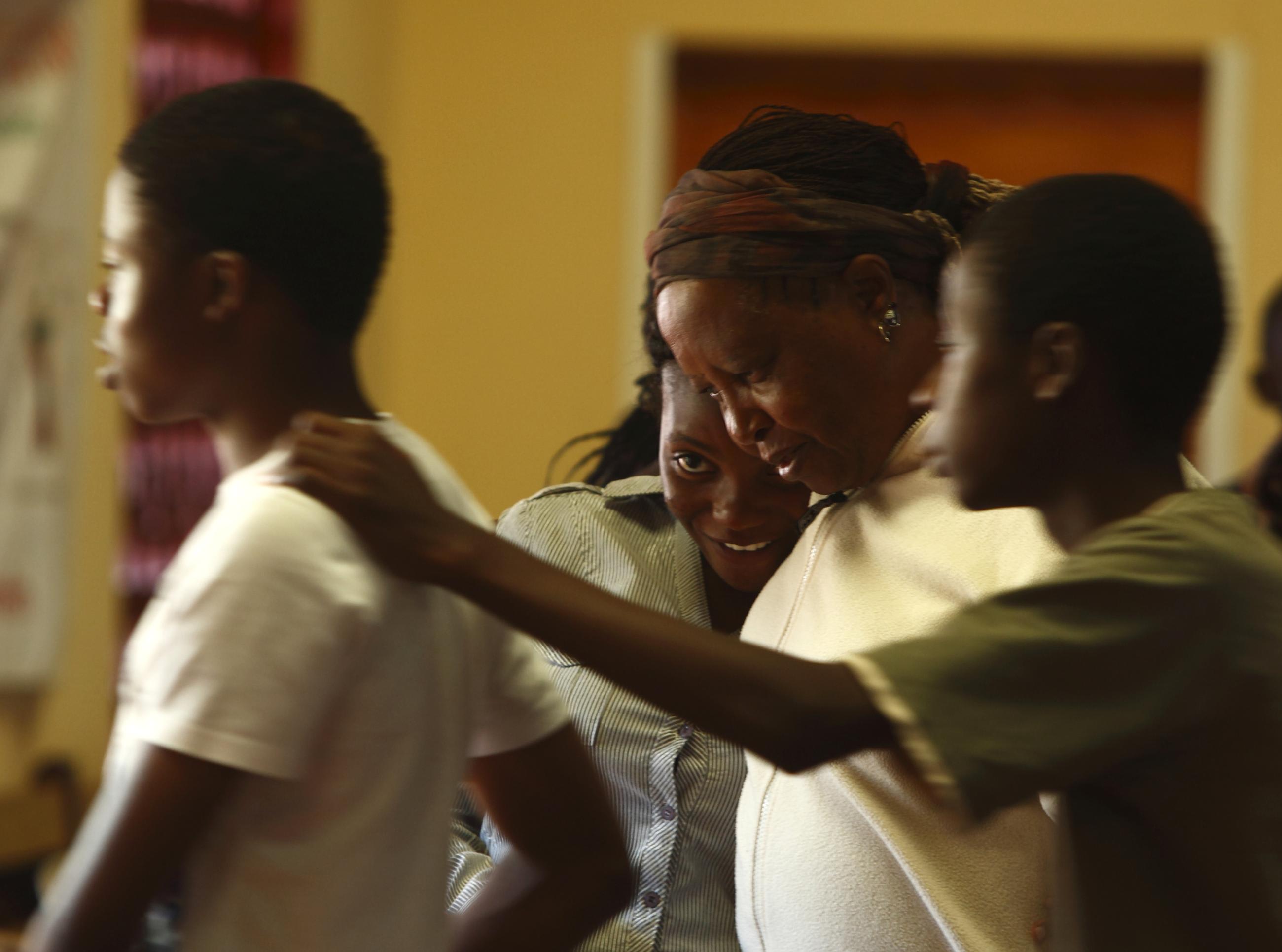 A facilitator consoles a participant after a reflective and emotional session at a Youth Against AIDS training camp, in Domboshawa, Zimbabwe, on April 14, 2012.