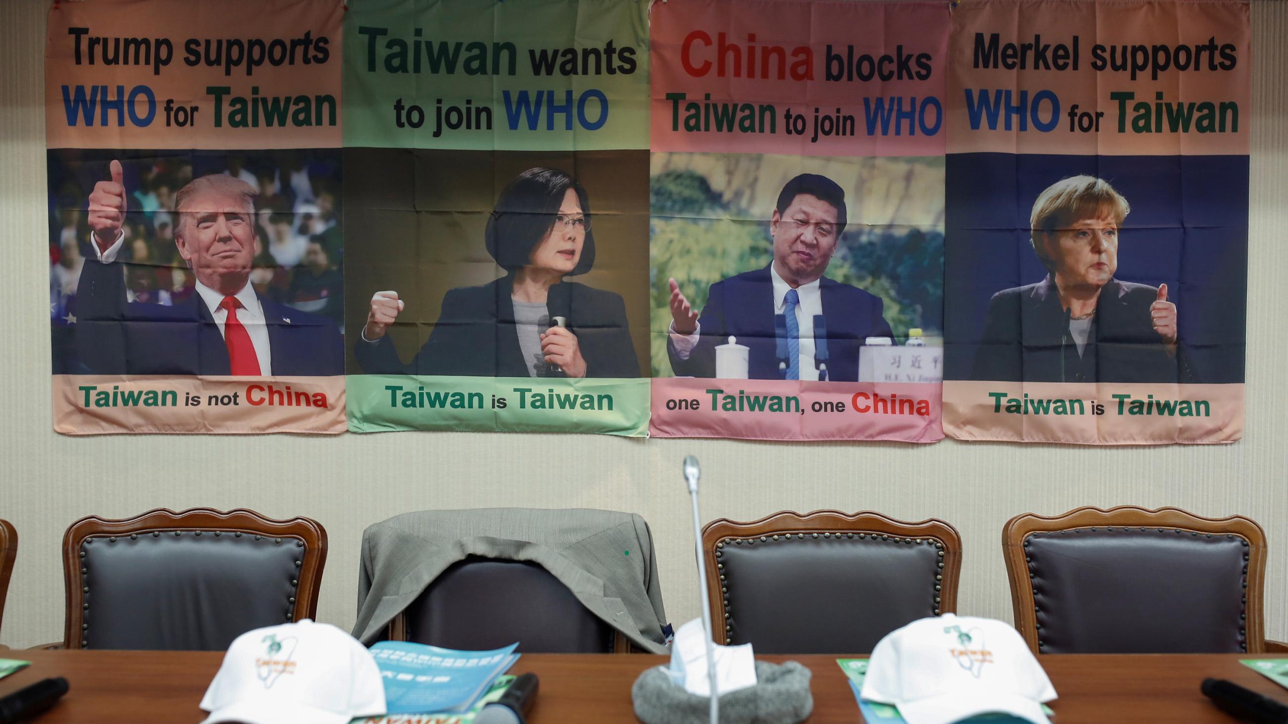 The photo shows empty seats, one with a jacket thrown over the back of it, with posters in the background showing testimonials by world leaders in support of Taiwan's WHO bid.