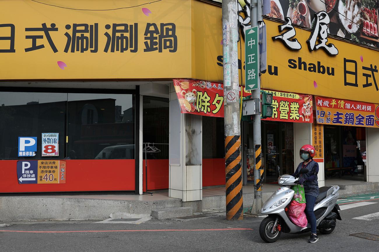 Photo shows a motorcycle on an abandoned street in an urban setting.