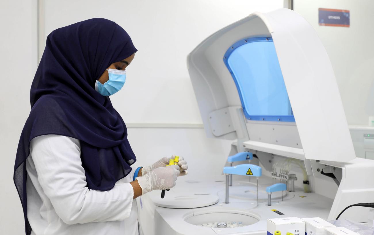 Laboratory technician Wardo Abdalla sits in front of a large screen and works at Medipark Diagnostics Lab where COVID tests are run, in Mogadishu, Somalia on October 14, 2020.