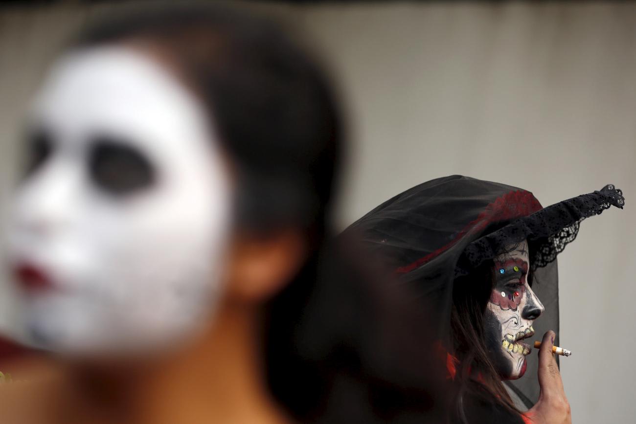 A woman, painted to look like the popular Mexican figure 
