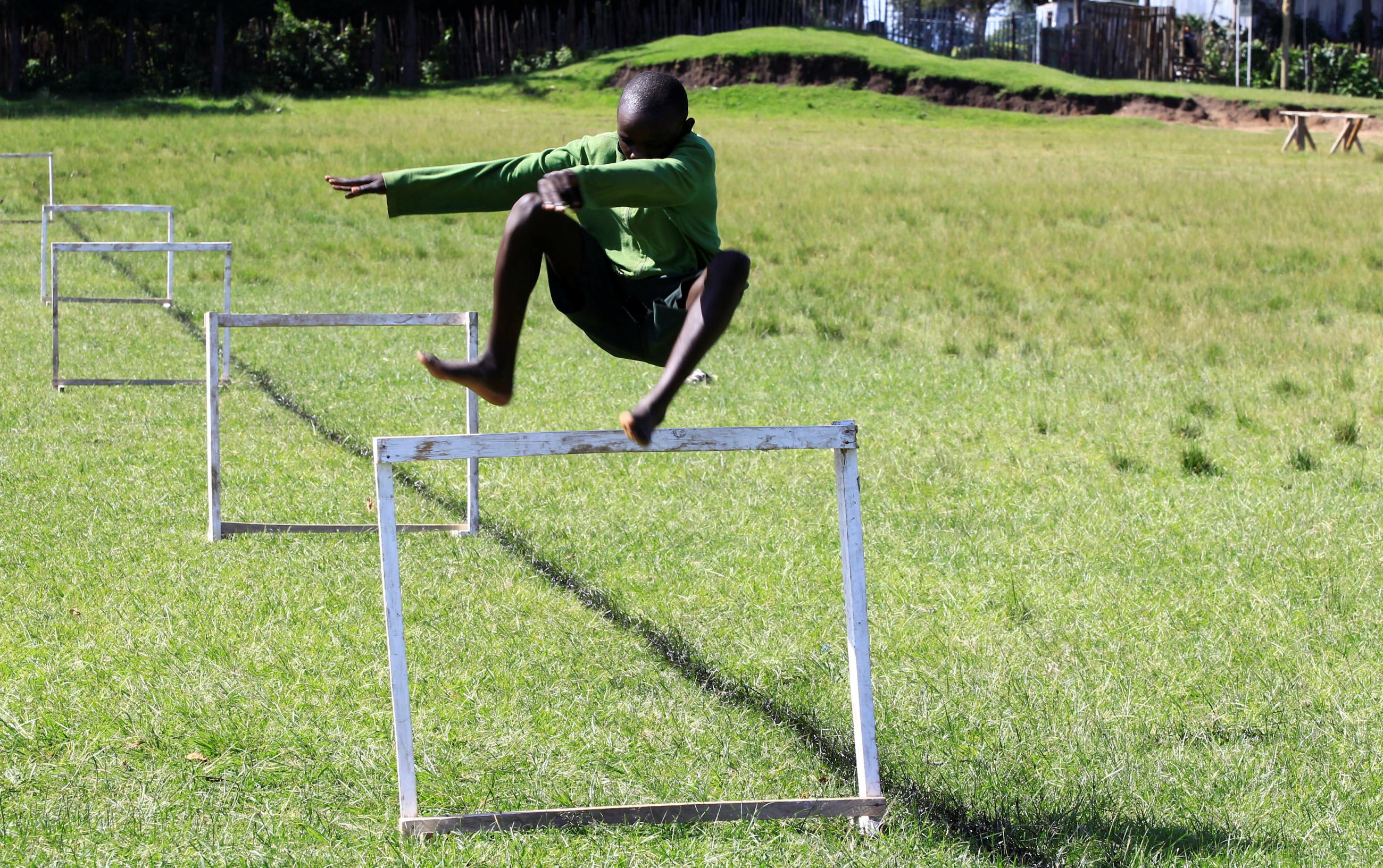 A student at Kamoi Primary School jumps a hurdle during a steeplechase exercise session at his school's field in Elgeyo-Marakwet County, Kenya, on August 6, 2021.