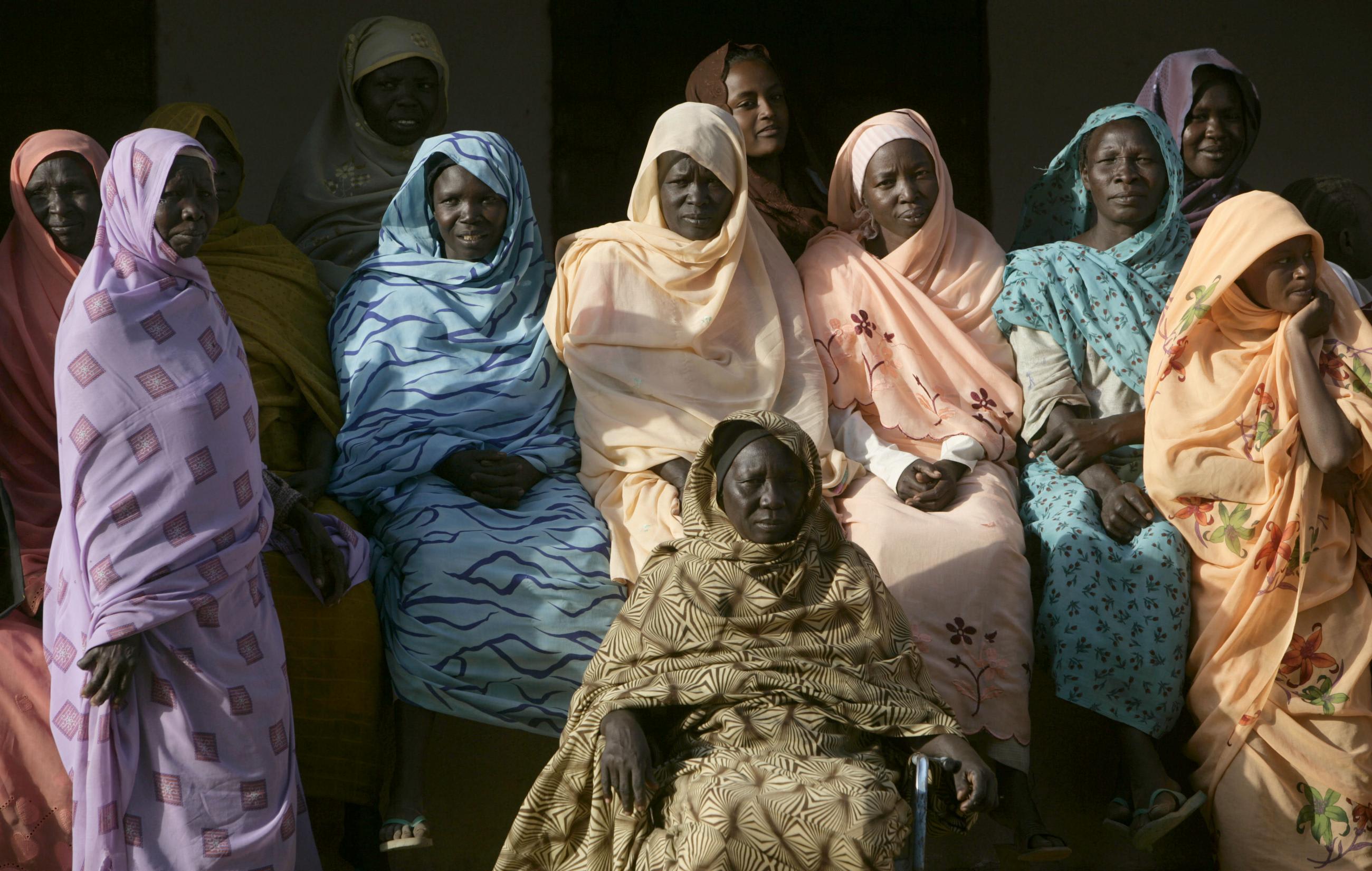 Women from the village of El Moriib in the Nuba Mountains listen to a Sudanese Red Crescent instructor explain how to protect their families from malaria by using mosquito nets, on December 10, 2006.