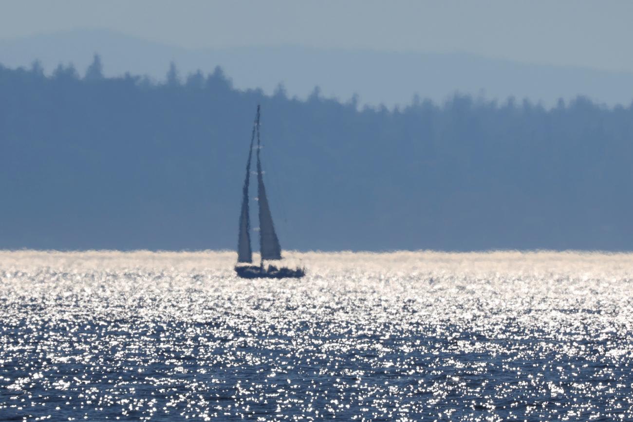 A sailboat is seen off Alki Beach during a heat wave in Seattle, Washington, on June 27, 2021.